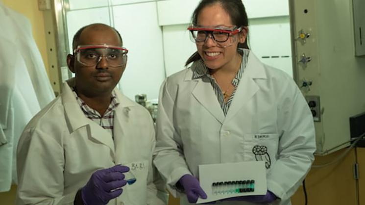 Rice University research scientist Babu Ganguli and graduate student Kimmai Tran show test tubes with their eutectic solvent and varying concentrations of cobalt drawn into the solution.