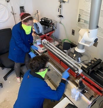 Rice University graduate students Lauren Taylor and Oliver Dewey work to refine the process of making threadlike fibers from carbon nanotubes. Their fibers now surpass the strength of Kevlar. Courtesy of the Pasquali Research Group